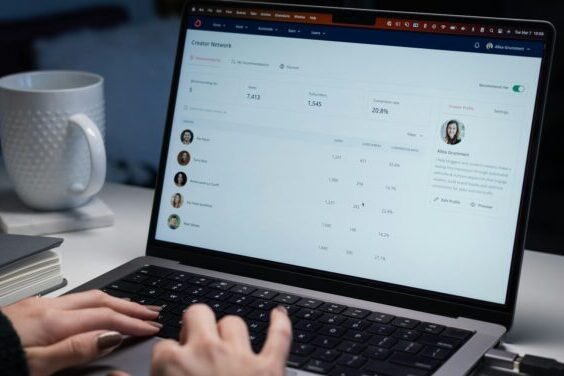 a person typing on a laptop computer on a desk